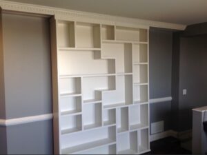 Custom built-in shelving wall in a finished basement